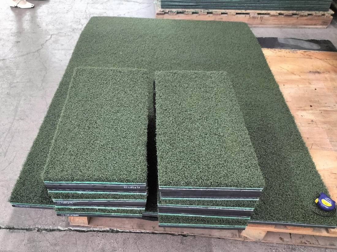 RealStrike stance mats and hitting strips stacked on a factory pallet